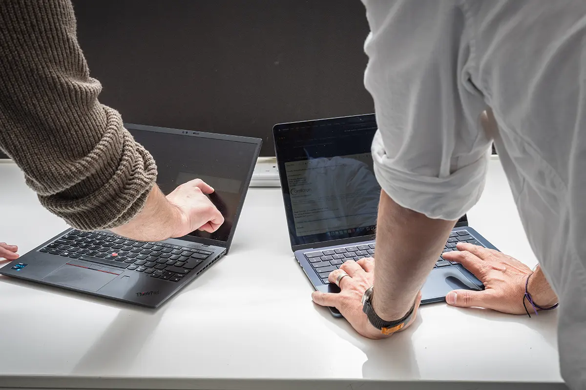 Close up of omicron employees working on computers